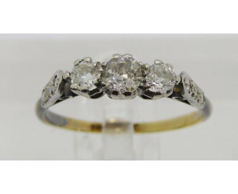 18ct platinum set three stone diamond ring with further diamond set shoulders, centre stone 0.20ct approx, outer stones 0.10c