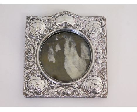 An Early 20th Century Art Nouveau embossed silver photograph frame, Henry Mathews, Chester, (date letter indistinct), 14cm x 