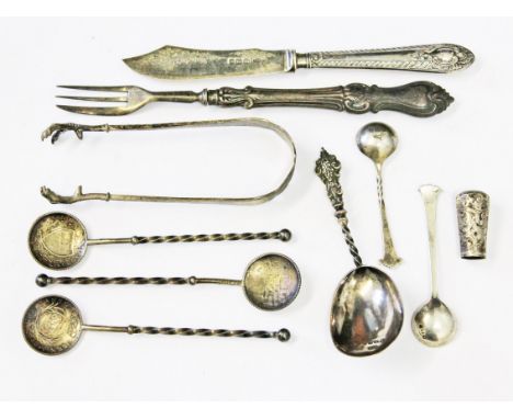 A mixed lot of silver to include a Victorian hallmarked silver caddy spoon, German silver spoons and sugar tongs etc.