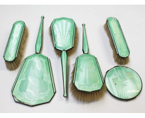 A six piece hallmarked silver and enamel dressing table set comprising four brushes, a mirror and a compact.