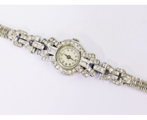 An Art Deco white metal diamond cocktail watch with later 9ct white gold strap, gross wt. 25g.