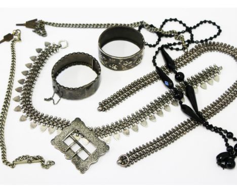 A mixed lot comprising a hallmarked silver belt buckle, two silver plated Albert chains, a bangle marked Sterling, white meta