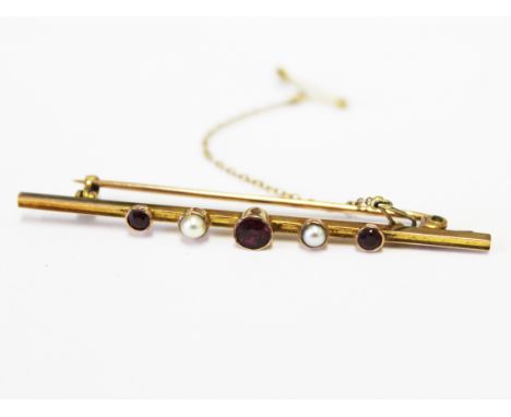A 9ct gold seed pearl and purple stone brooch, length 6cm, gross wt. 3.4g.
