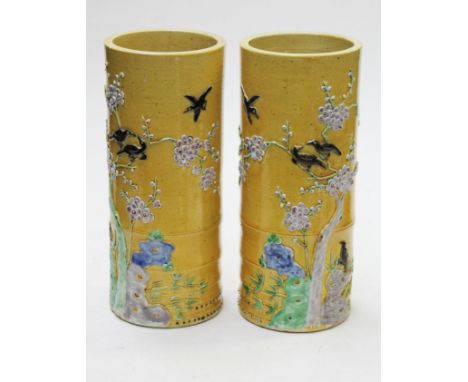 A pair of Chinese porcelain vases with applied prunus decoration on yellow ground bearing six character Kangxi marks, height 