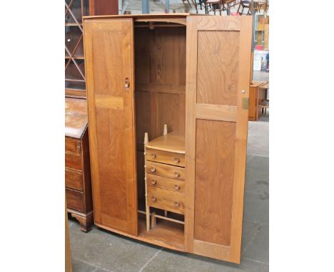 An Ercol light elm and beech wardrobe with interior drawers. W91cm D56cm H181cm.