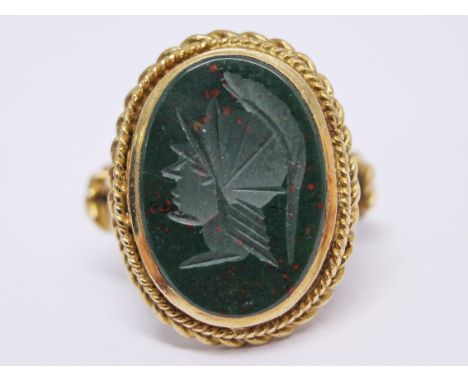 A 9ct gold ring with green stone etched with a Roman Centurion, gross wt. 5.8g, size M.
