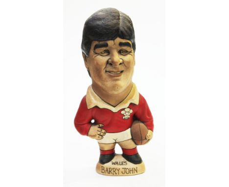 A Groggs ceramic figure of Barry John, height 24cm. Condition - good, general wear. 