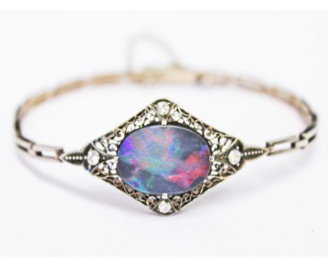 A Belle Epoque style black opal and diamond white metal bracelet, the centre stone approx. 17mm x 11mm, gross wt. 9g, with as