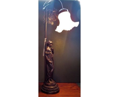 A contemporary table lamp in the form of a semi-clad lady in the classical form.