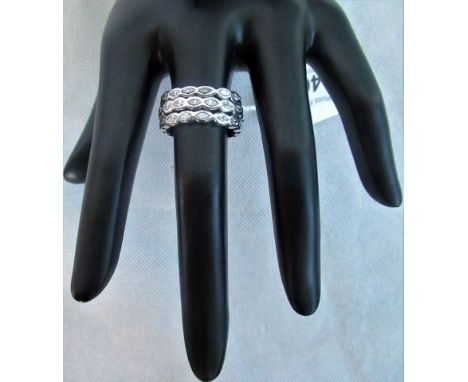 A three row diamond ring, the marquise cut diamonds horizontally set in rub-over mounts.
