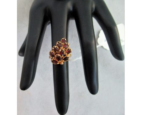 A lady's ruby set cluster ring of leaf design.