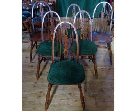 A set of six oak stick back dining chairs (2 carvers, 6 standard).