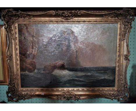 A large gilt framed oil on canvas, seascape rocky cost line and cliffs.