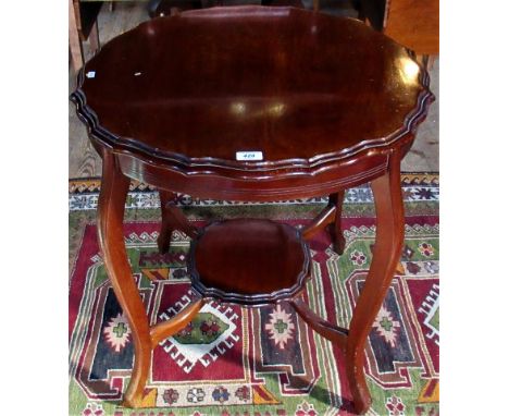 An Edwardian mahogany two tier occasional table, bearing the label R H Tucker.