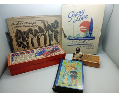 A child's tin Babes in the Wood money box, vintage puzzles and two 1923 opera programmes bearing some signatures and with nic
