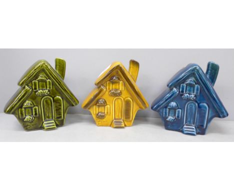 Three ceramic Trentham Art ware money boxes in the form of houses 