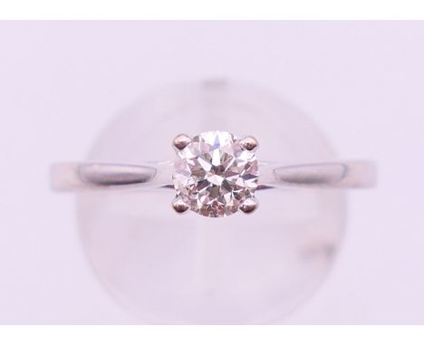 An 18 ct white gold diamond solitaire ring. The claw set stone approximately 0.5 carat. Ring size R. 