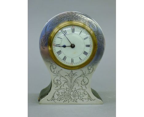 An Edwardian silver cased balloon-shaped mantle clock with enamelled dial, Birmingham 1904. 13 cm high.