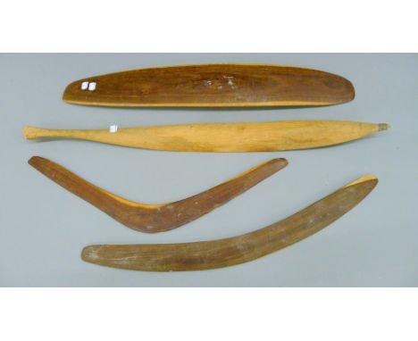 Four Australian Aboriginal items, consisting of two boomerangs, a spear thrower and a parrying shield. The latter 76.5 cm lon