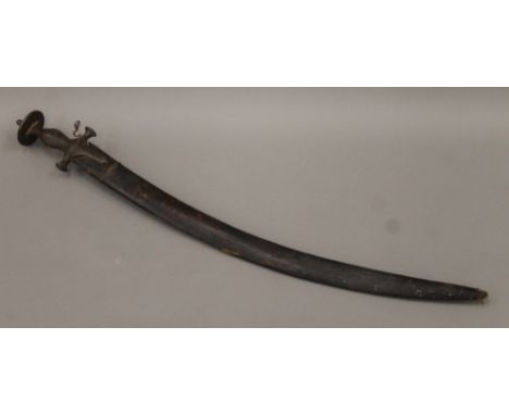 An antique tulwar, in leather scabbard. 79 cm long.