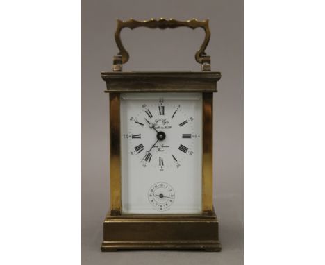 A brass-cased carriage alarm clock. 14.5 cm high.