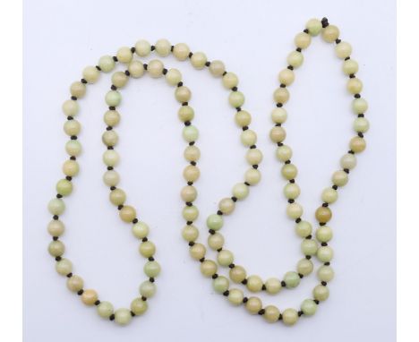 A string of celadon jade beads. 114 cm long. 