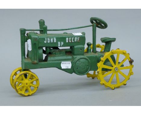 A cast iron model of a John Deere tractor. 28 cm long.