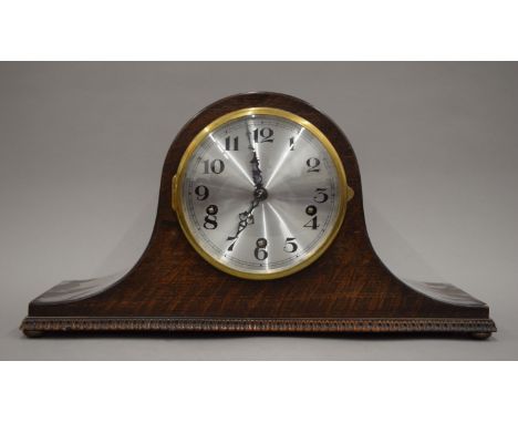 An early 20th century oak mantle clock.  44 cm wide. 