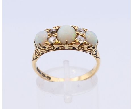 An 18 ct gold diamond and opal ring. Ring size Q/R. 
