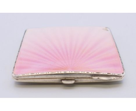 A silver and pink enamel compact, hallmarked Birmingham 1940. 6 cm wide. 94.8 grammes total weight. 
