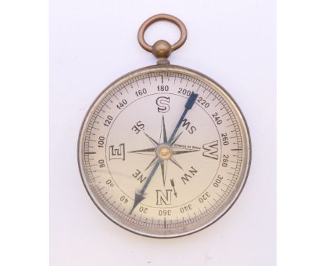 A brass cased compass with silvered dial. 5 cm diameter. 