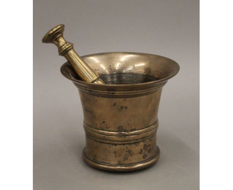 A 17th century bronze pestle and mortar. The mortar 11.5 cm high.