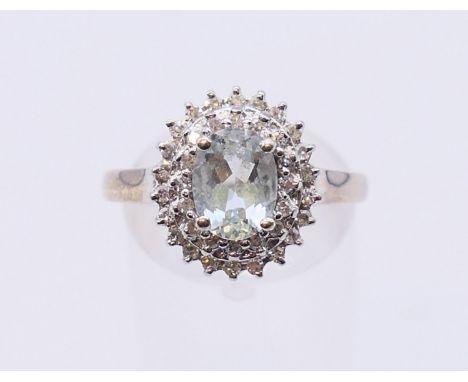 An unmarked white gold diamond and aquamarine ring. Ring size Q/R. 