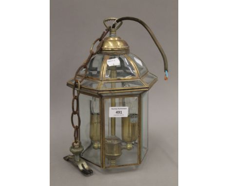 A brass hanging lantern. 32 cm high.