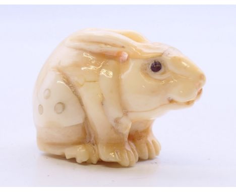 A bone netsuke formed as a rabbit/hare. 4.5 cm long. 