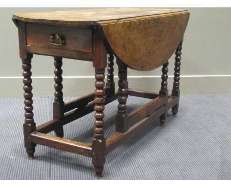 An 18th century and later oak gateleg table on bobbin turned supports, 64 x 118 x 44cm (closed) 64 x 118 x 94cm (open)