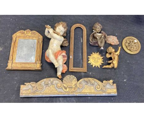 A painted wooden model of a cherub, 56cm long, an Italian style mirror, 42 x 33cm, a carved giltwood cresting, a gilt wooden 