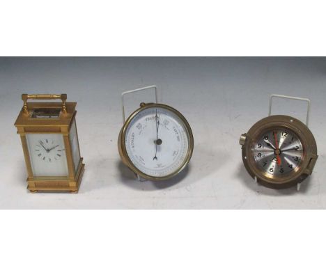A 20th century gilt brass carriage timepiece, a brass aneroid barometer, and a battery clock