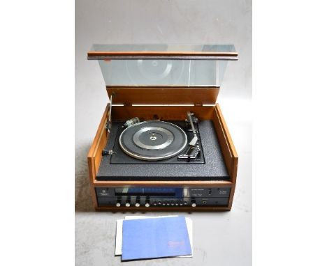 A VINTAGE DYNATRON SRX 26 RADIOGRAM, with a teak exterior and smoked perspex lid, fitted with a Garrard SP25 MK2 turntable