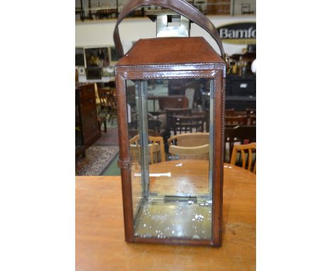 A contemporary leather cased lantern
