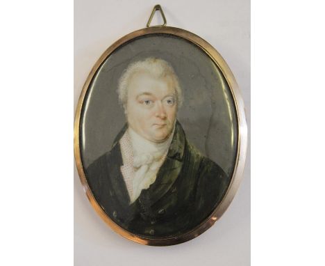 Early 19th Century watercolour portrait miniature of a gentleman wearing a black coat and white stock, in an oval gilt metal 