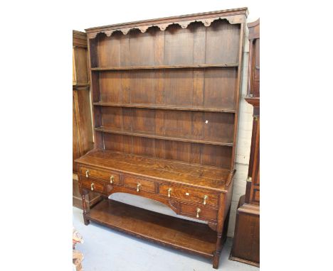 Early 19th Century oak dresser, the boarded shelf back above an arrangement of five drawers, baluster turned supports and und