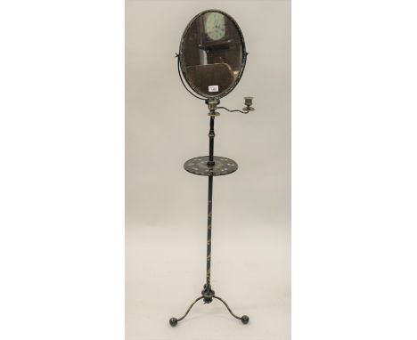19th Century black japanned gilded metal and papier mache shaving stand, the oval swing frame mirror above a pair of candle h