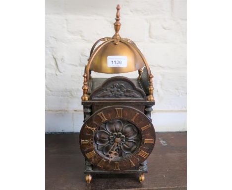 20th Century oak and gilded brass lantern style mantel clock, the dial with Roman numerals, engraved with a rose, having sing
