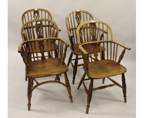 Harlequin set of four 19th Century ash and elm Windsor chairs, the hoop stick and pierced splat backs above carved panel seat