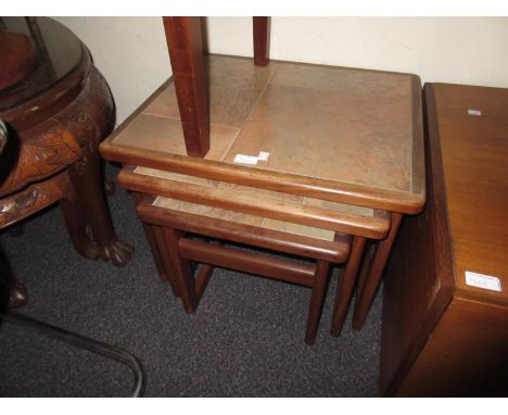 Nest of three Danish teak tile inset occasional tables 