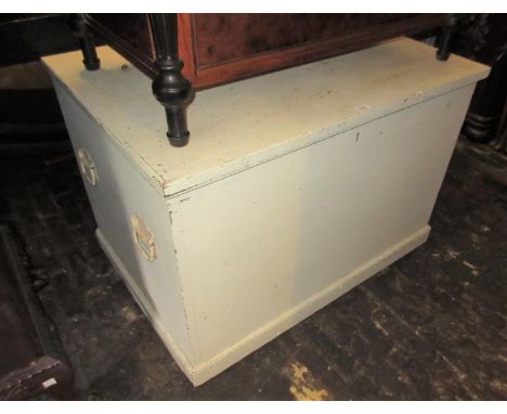 Large white painted pine trunk with hinged cover and iron end handles, 39ins wide 