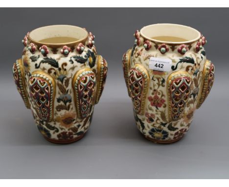 Pair of Zsolnay Pecs oviform vases of typical design decorated with reticulated relief panels on a floral field with cream gr