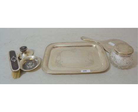 Birmingham silver dressing table set comprising a rectangular floral engraved tray, matching hand mirror, matching jar and co