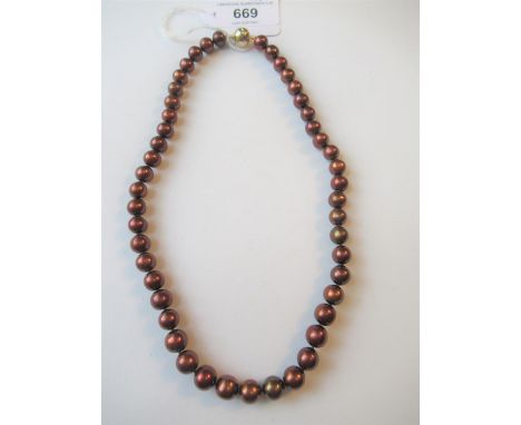 Single row chocolate cultured pearl necklace with a 9ct yellow and white gold ball form clasp45cm in lengthOf recent manufact